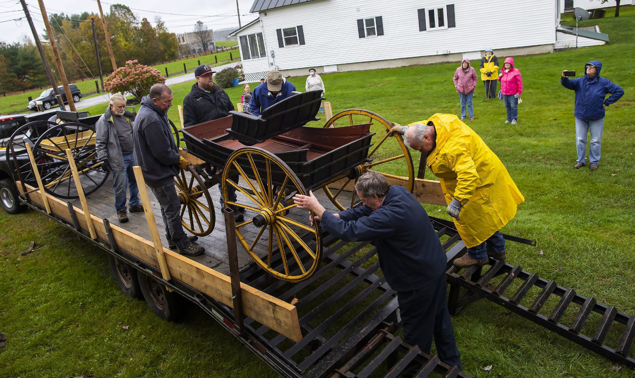 With the help of the Penacook Historical Society, the Abbot-Downing Historical Society was able to store of its eight 19th century coaches and carriages at the Rolfe Barn on Penacook Street on Tuesday, October 27, 2021. The members of the Abbot-Downing Historical Society roll one of the carriages off the flatbed to be put in the barn. GEOFF FORESTER