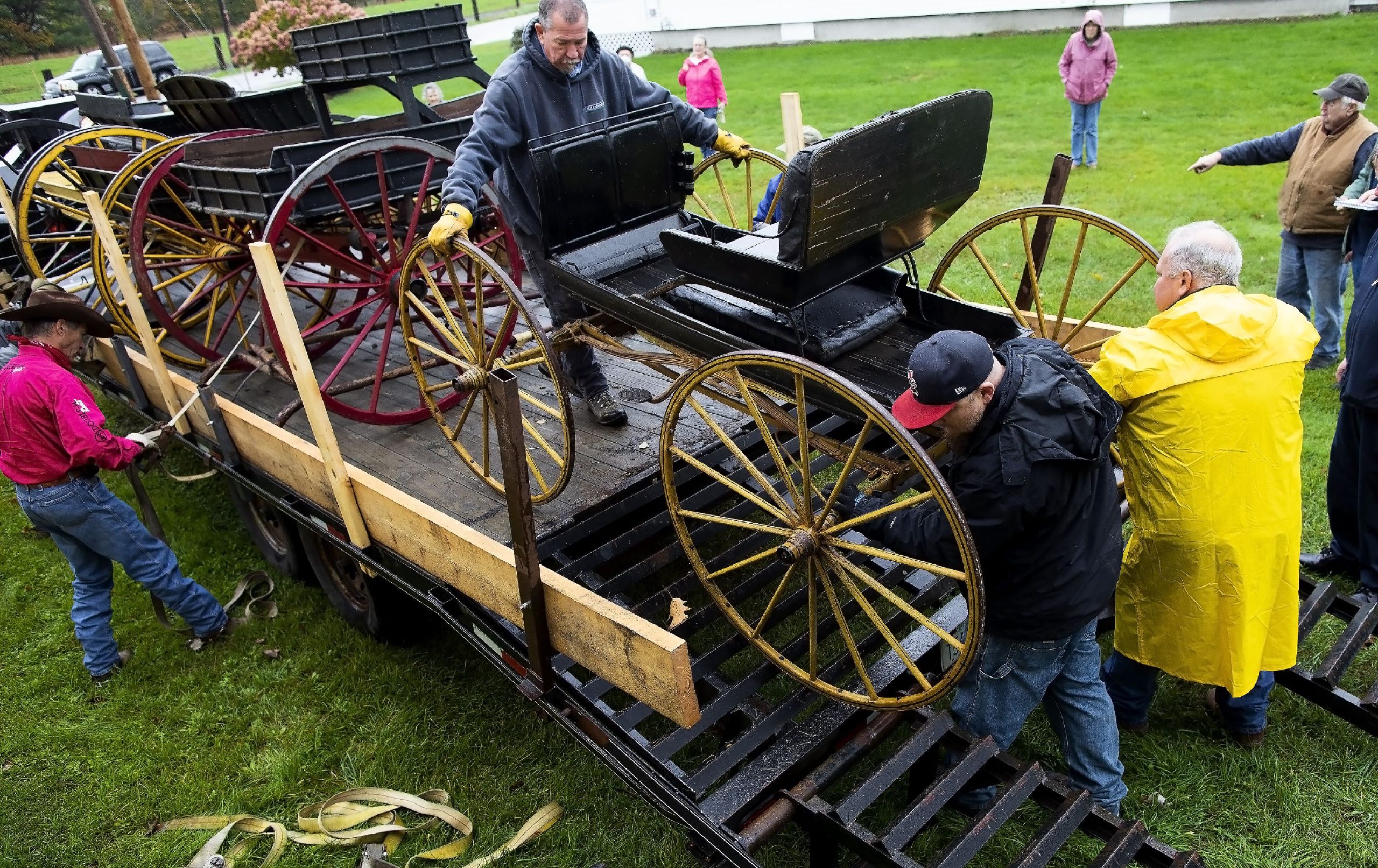 With the help of the Penacook Historical Society, the Abbot-Downing Historical Society was able to store of its eight 19th century coaches and carriages at the Rolfe Barn on Penacook Street on Tuesday, October 27, 2021. The members of the Abbot-Downing Historical Society roll one of the carriages off the flatbed near the barn. GEOFF FORESTER