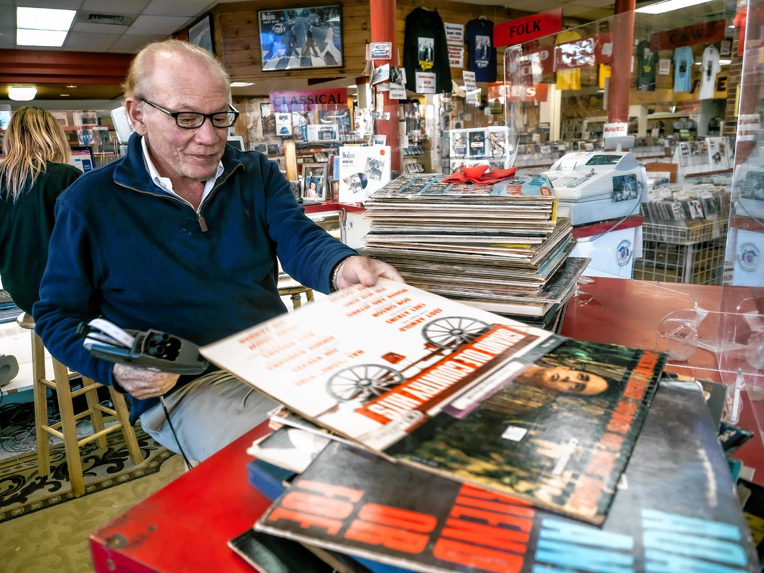 Pitchfork Records owner Michael Cohen sifts through albums to mark for pricing at the downtown store on Wednesday, November 9, 2022. GEOFF FORESTER