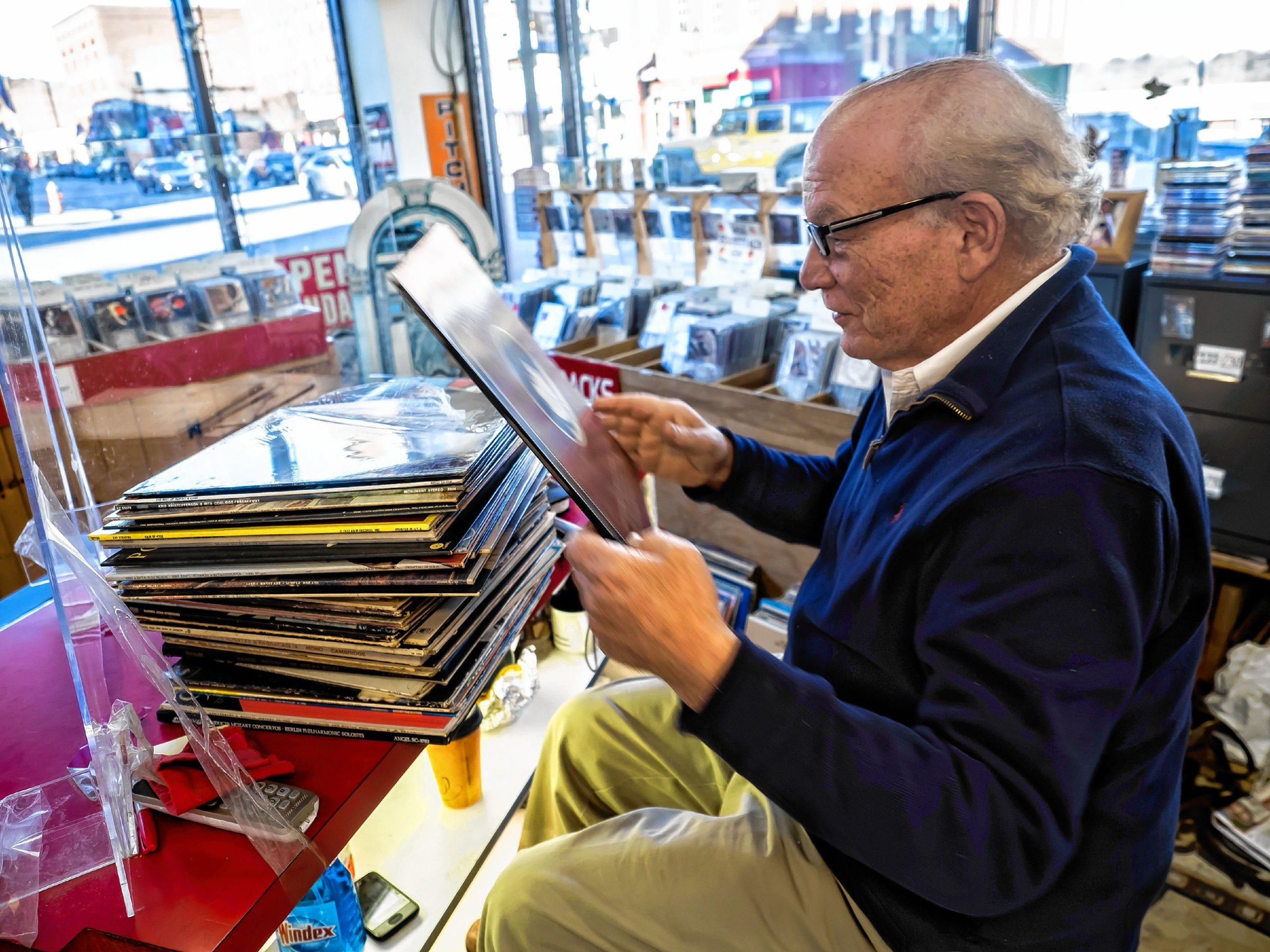 Pitchfork Records owner Michael Cohen sifts through albums to mark for pricing at the downtown store on Wednesday, November 9, 2022. GEOFF FORESTER