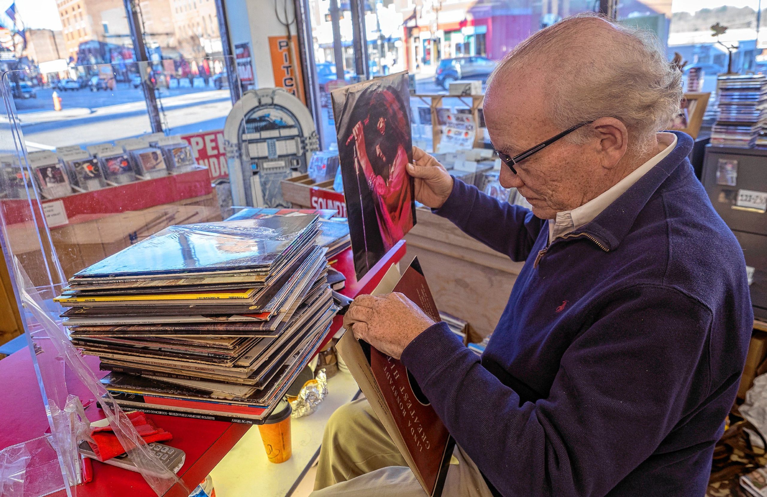 Pitchfork Records owner Michael Cohen sifts through albums to mark for pricing at the downtown store on Wednesday, November 9, 2022. GEOFF FORESTER