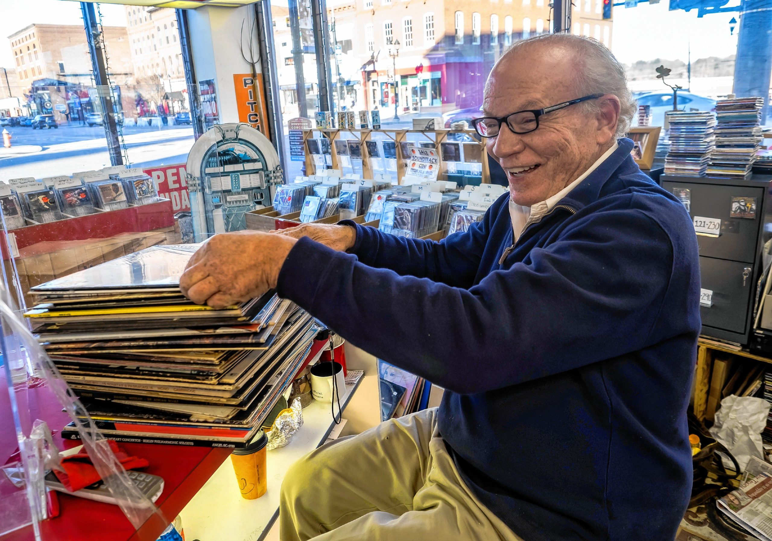 Pitchfork Records owner Michael Cohen sifts through albums to mark for pricing at the downtown store on Wednesday, November 9, 2022. GEOFF FORESTER