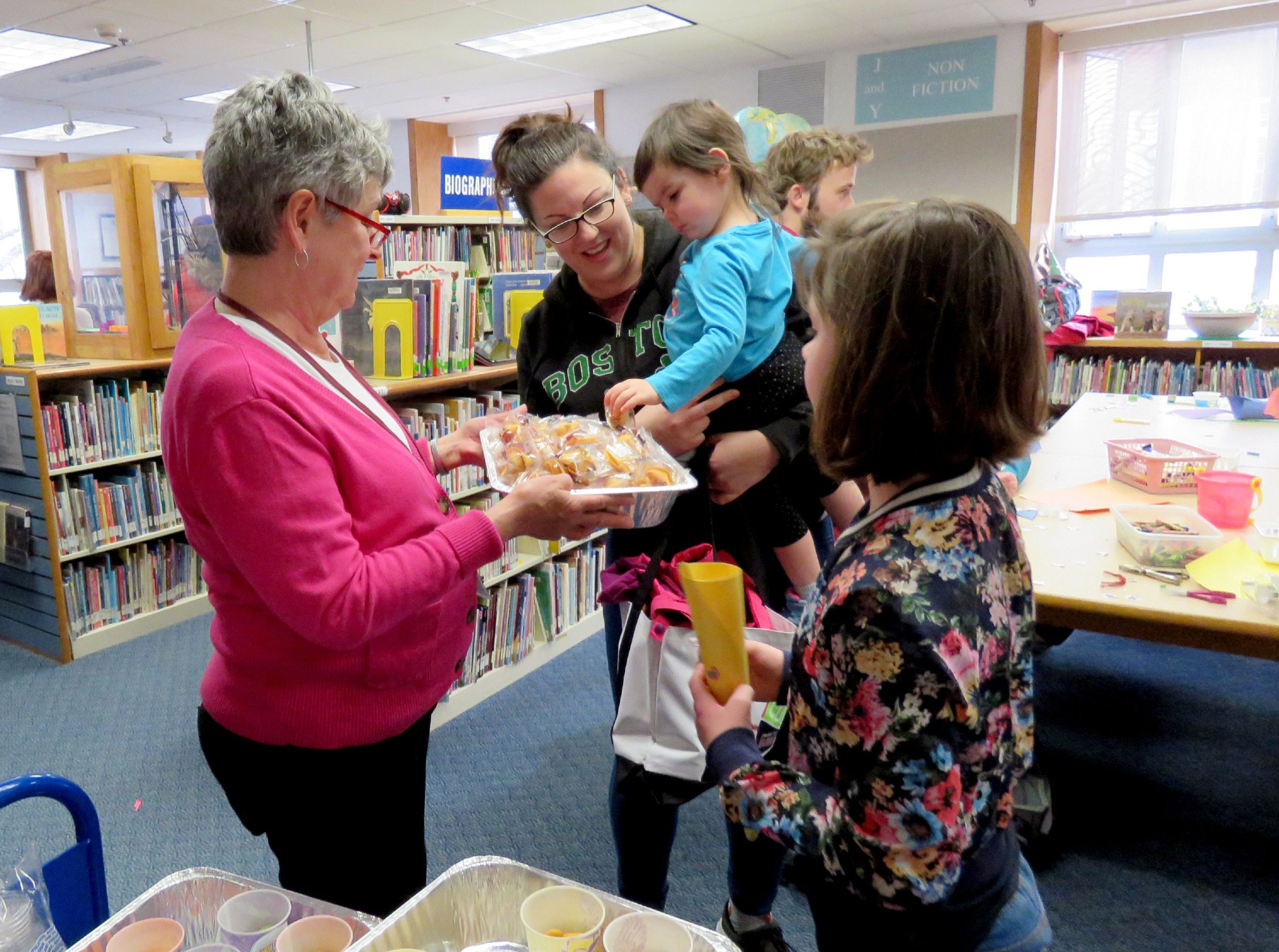 Concord Public Library's children's services manager Pam Stauffacher hands out treats to library visitors on Dec. 31, 2018. 