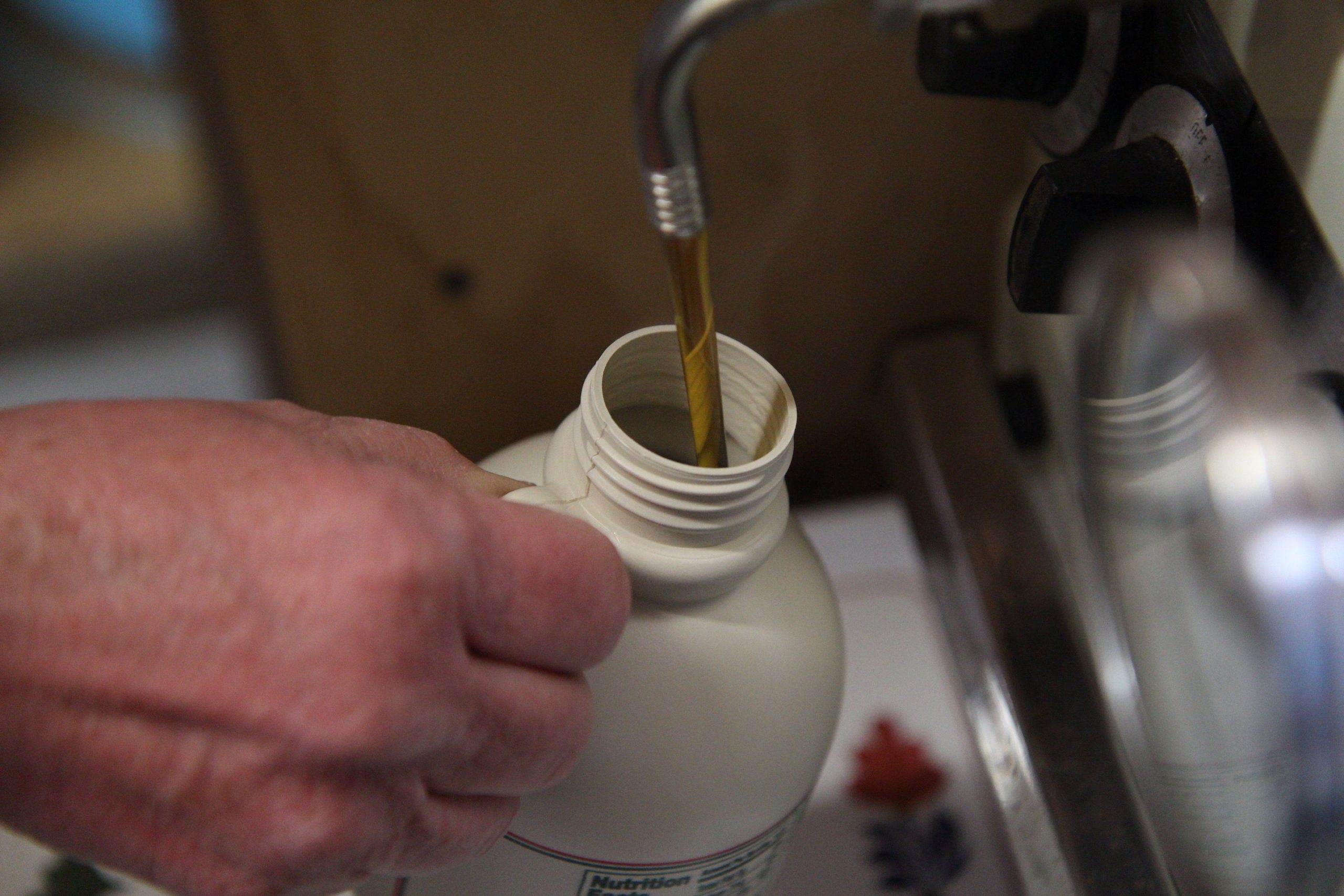 Barbara Lassonde fills a bottle of maple syrup on Thursday. It's one of the various preparations Beaver Meadowbrook Farm is making for the Kearsarge Maple Festival, which takes place in Warner during New Hampshire Maple Weekend.  