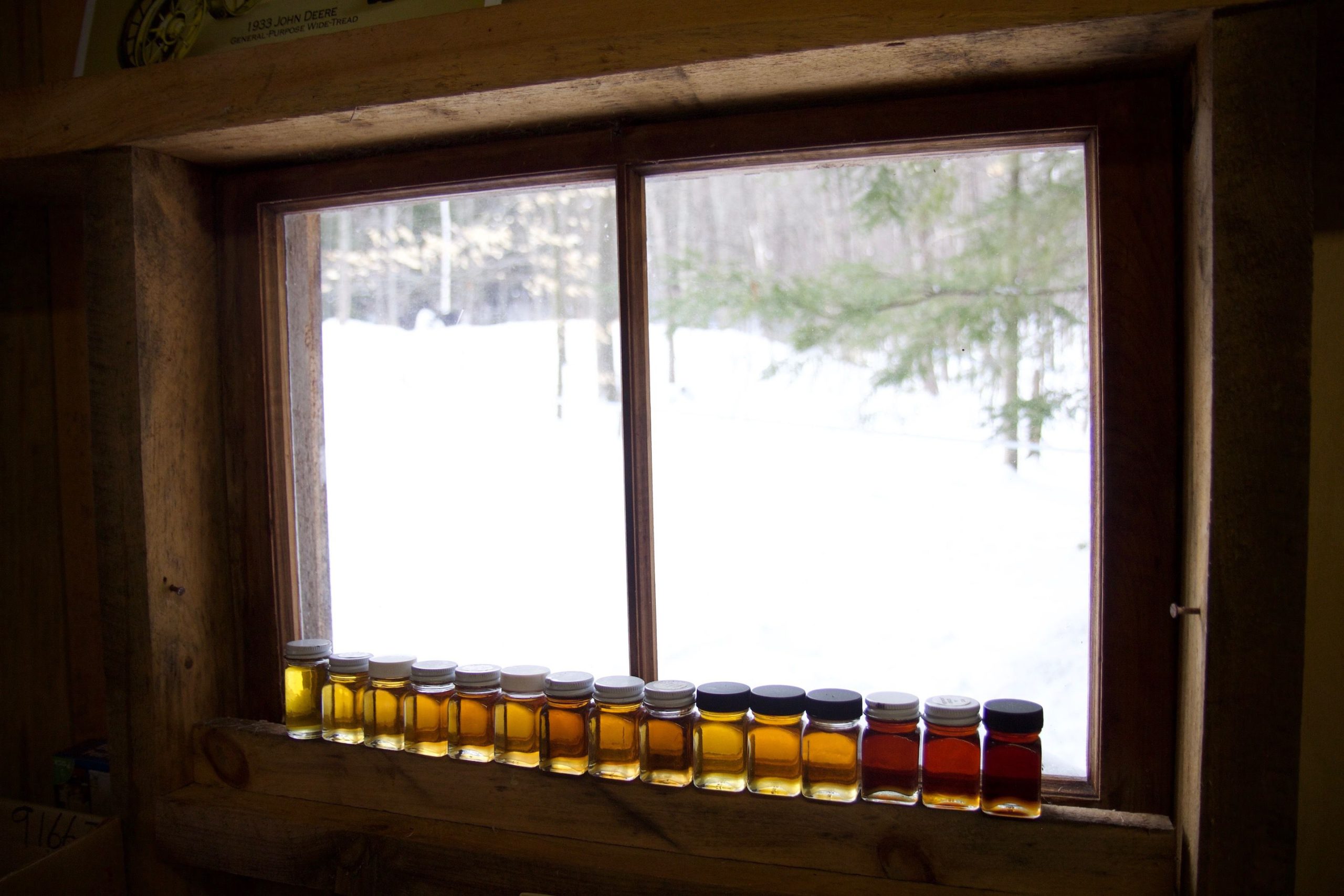 Samples of maple syrup sit along the windowsill in Barbara and Don Lassonde's Warner sugar house. The couple started making maple syrup in 1972 in Concord. 