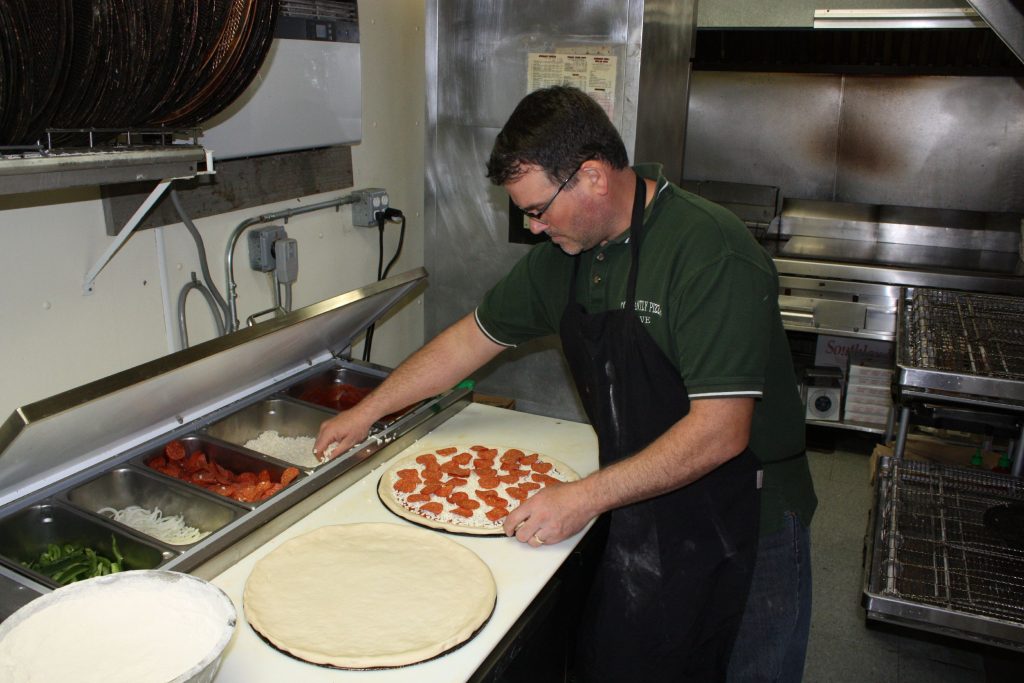 Constantly Pizza co-owner Dave Constant whips up a pepperoni pizza at the downtown location last week. Constant has been making pizza for so long now he can spin a dough on his finger like a Harlem Globetrotter does with a basketball. JON BODELL / Insider staff