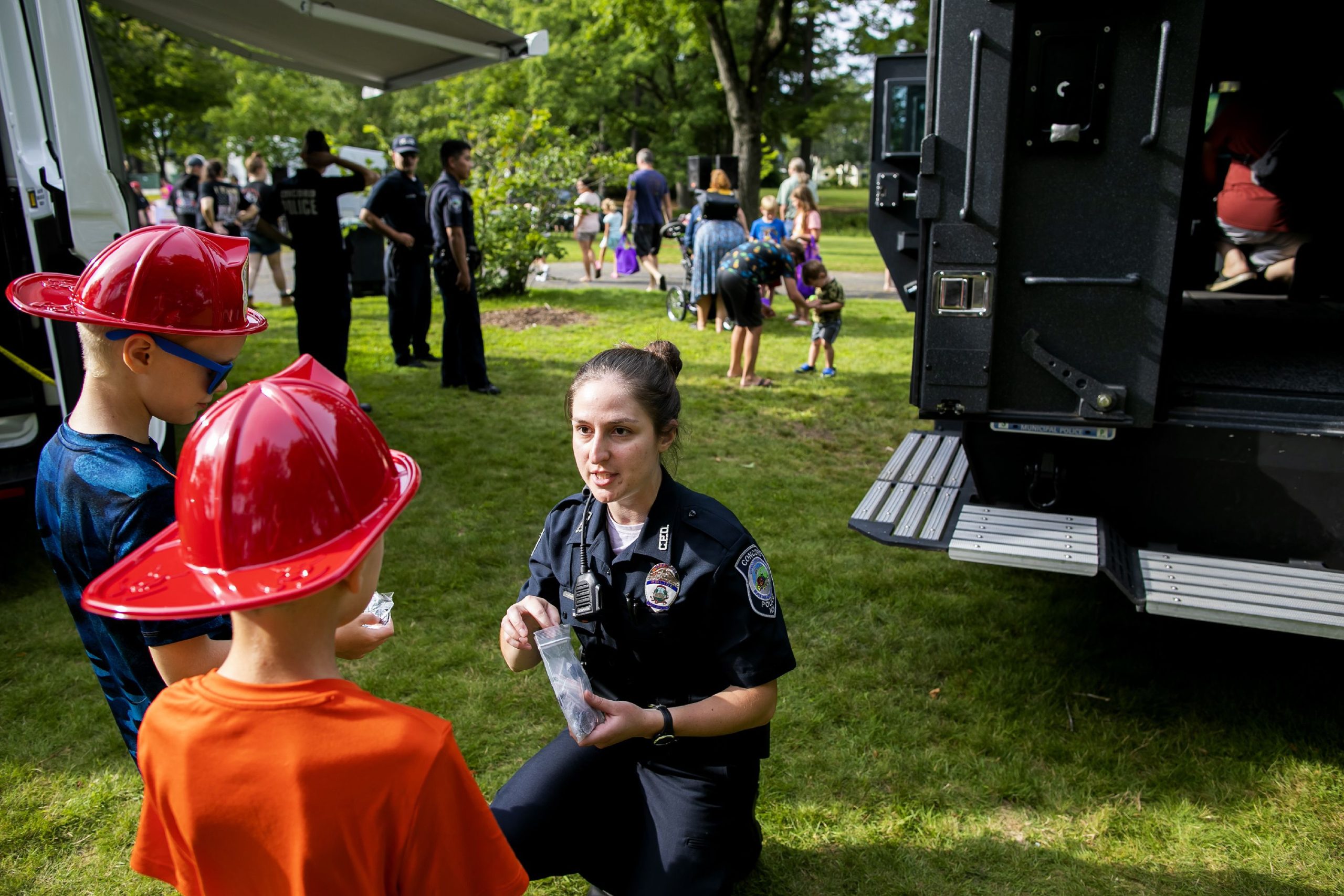 New Concord police officer Laura Dzgoeva hands out gifts to kids at the National Night Out at Rollins Park on Tuesday, August 3, 2021. Dzgoeva speaks both Russian and German and joined the force this year. 