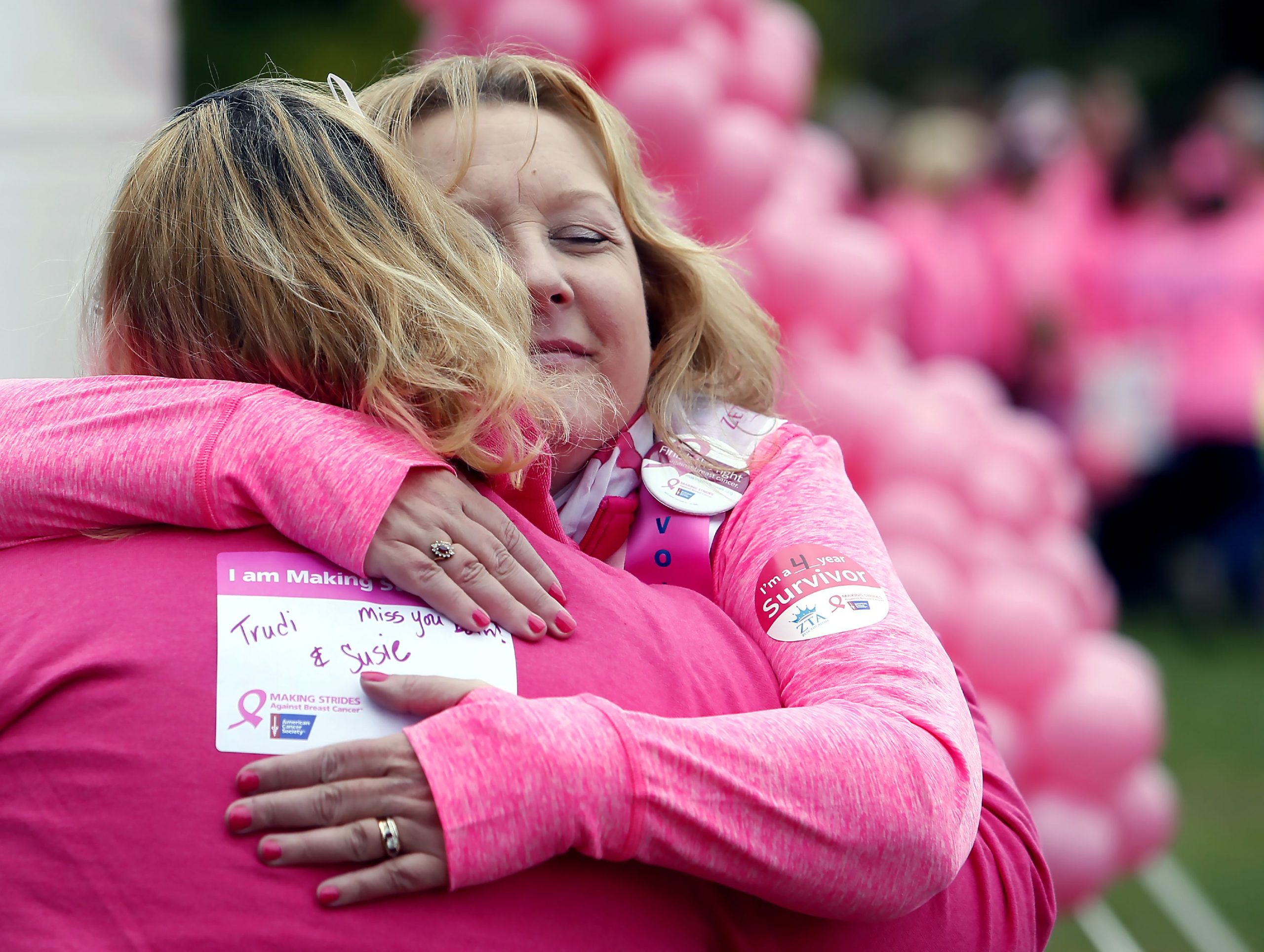 Nurse Patty Labrie of Manchester hugs another survivor before the 2016 Making Strides against Breast Cancer Walk at Memorial field Sunday. Labrie says the Concord American Cancer Society event is like family for her. 