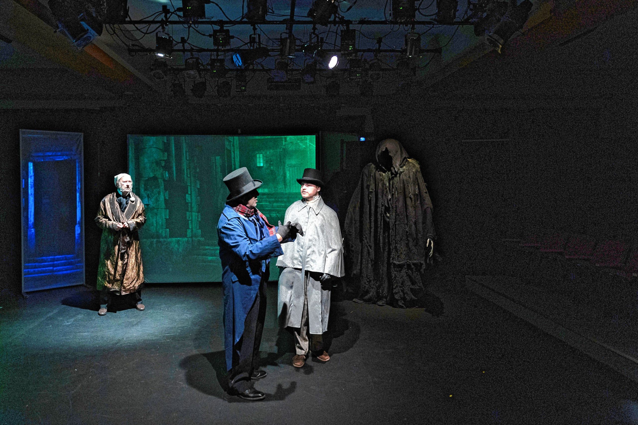 Erik Hodges as Scrooge with Jim Speigel and Erik Shaffer as Businessmen.